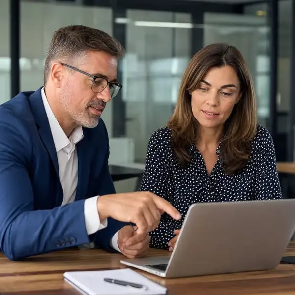 A team leader mentoring an established team member, illustrating continuity and retention