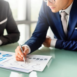 business-ceos-reviewing-data-charts